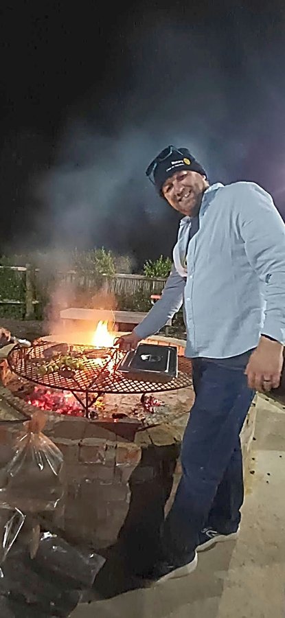 Justin Schonegevel works the coals